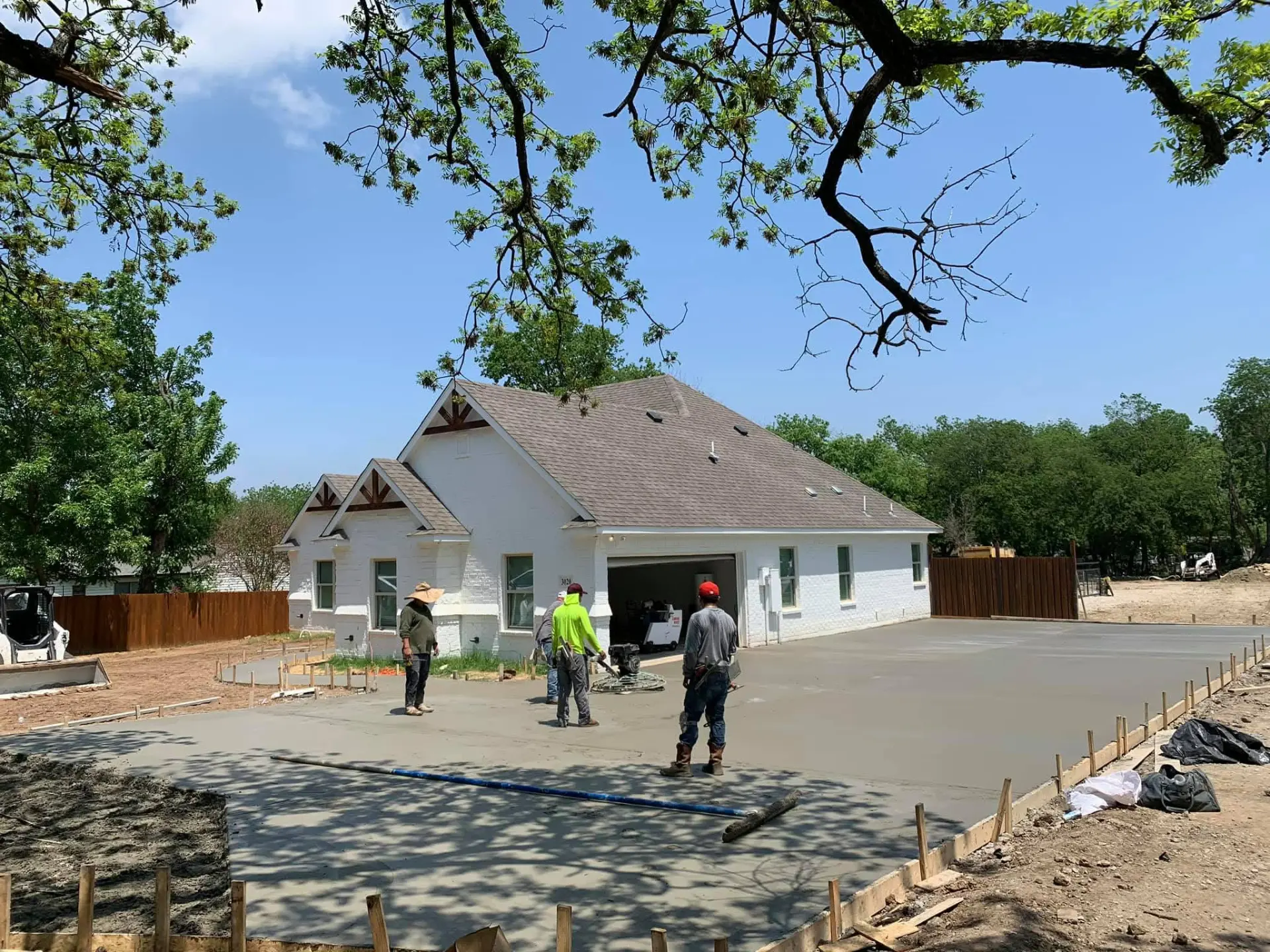 DC Stone & Lumber Design crew finishing a concrete driveway in Dallas Fort Worth
