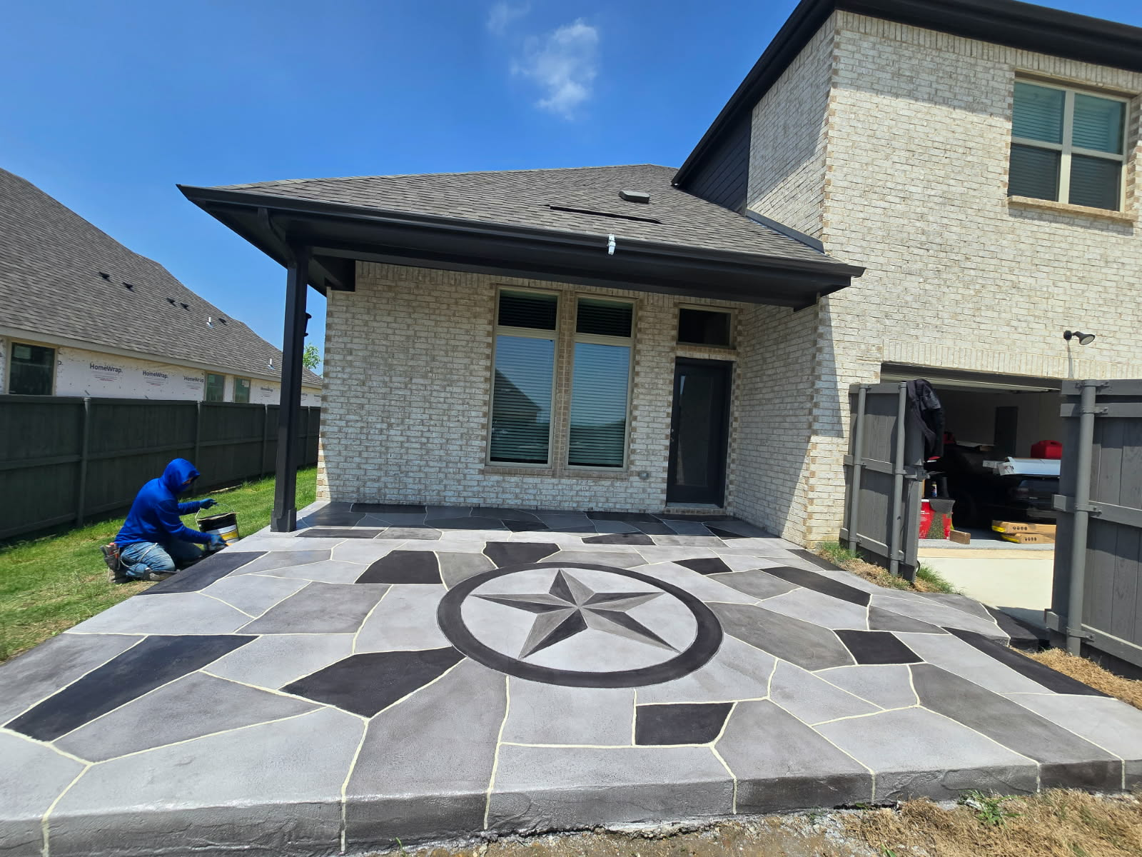 Decorative concrete overlay driveway with a custom star medallion inlay