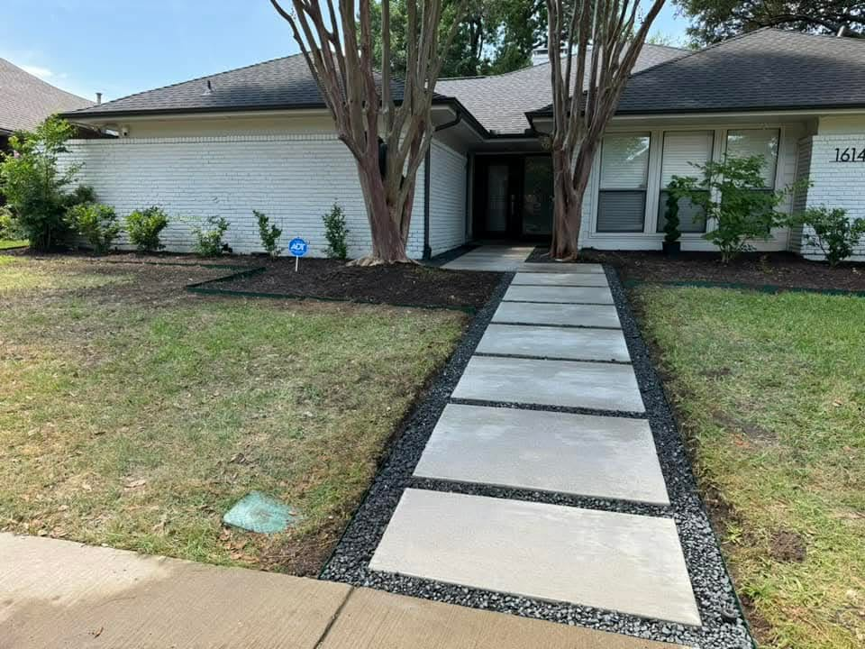 Poured concrete walkway and steps leading to a home entry